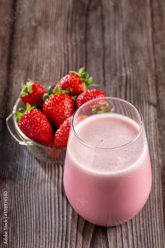 Glass with tasty strawberry smoothie.