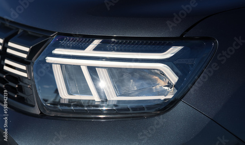 LED front light of a new Dacia Duster car. Detail view of the headlight. Romania, 2023. photo