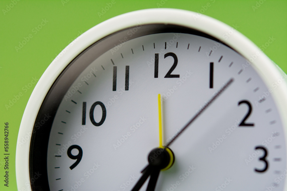 Alarm clock on green background, time concept, clock photo Alarm clock on green background, time concept, clock photo