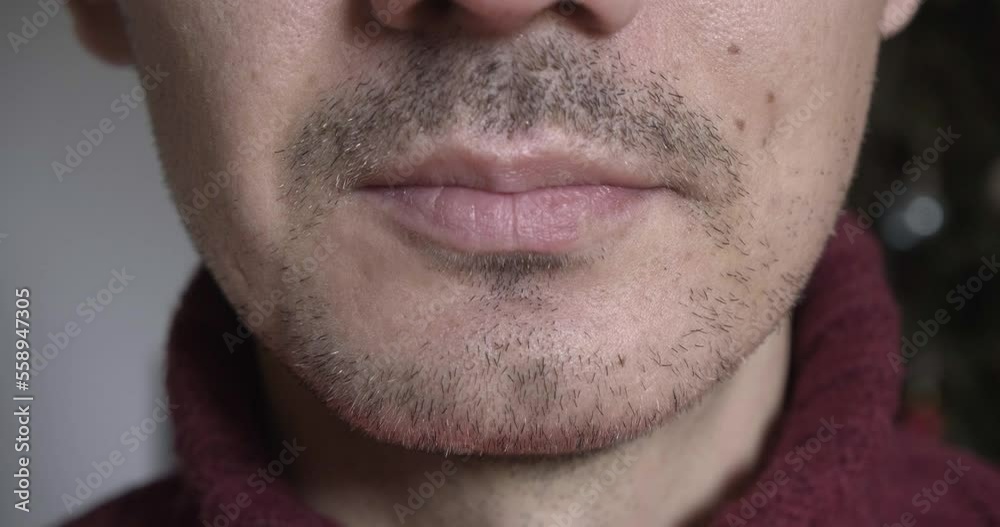 Close-up of a smiling man. A man with a slight unshaven smile Close-up of a smiling man. A man with a slight unshaven smile