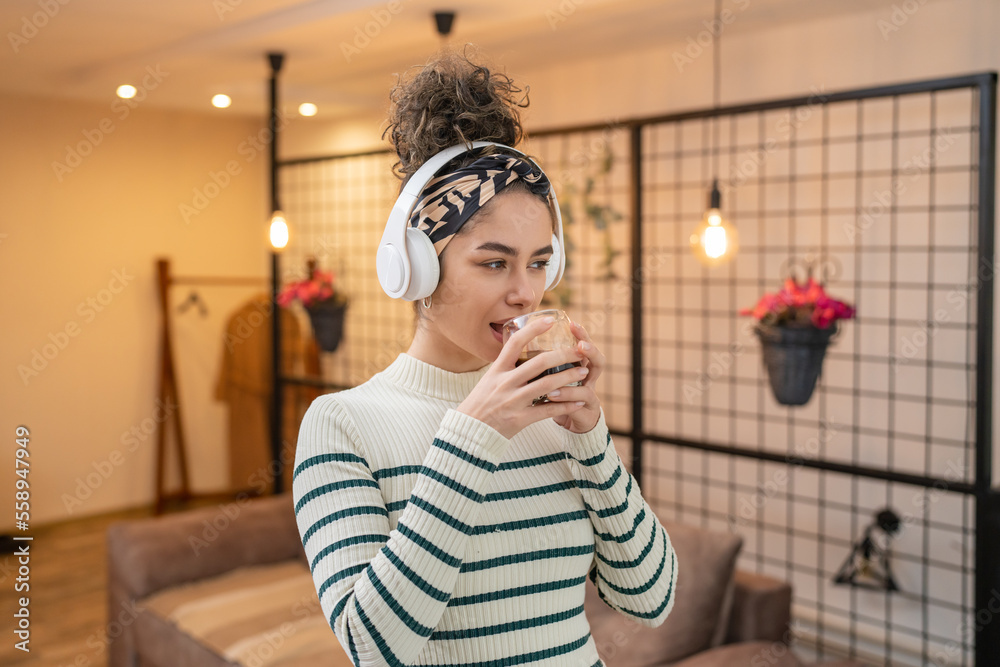 portrait of young beautiful woman with cup of coffee and headphones portrait of young beautiful woman with cup of coffee and headphones