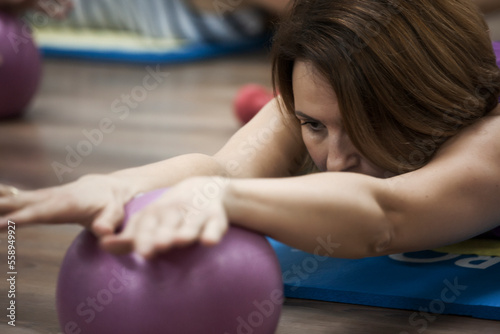 Woman doing pilates with ball