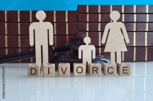 Separation of wooden figure of divorce family with gavel on wooden table in courtroom