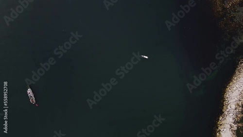 Aerial view of a small boat in the middle of the sea photo