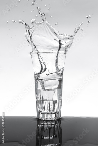  beer glass with dringking water splashing out.