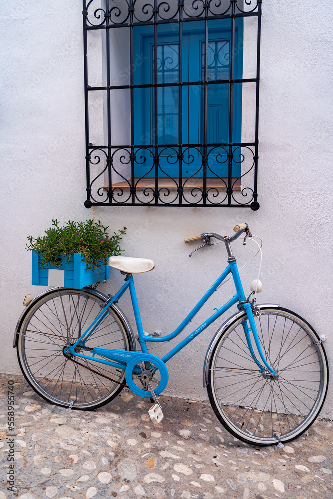 Blue bicycle used to decorate with plants the exterior facade of a house in the town of Altea on the Costa Blanca, Alicante.