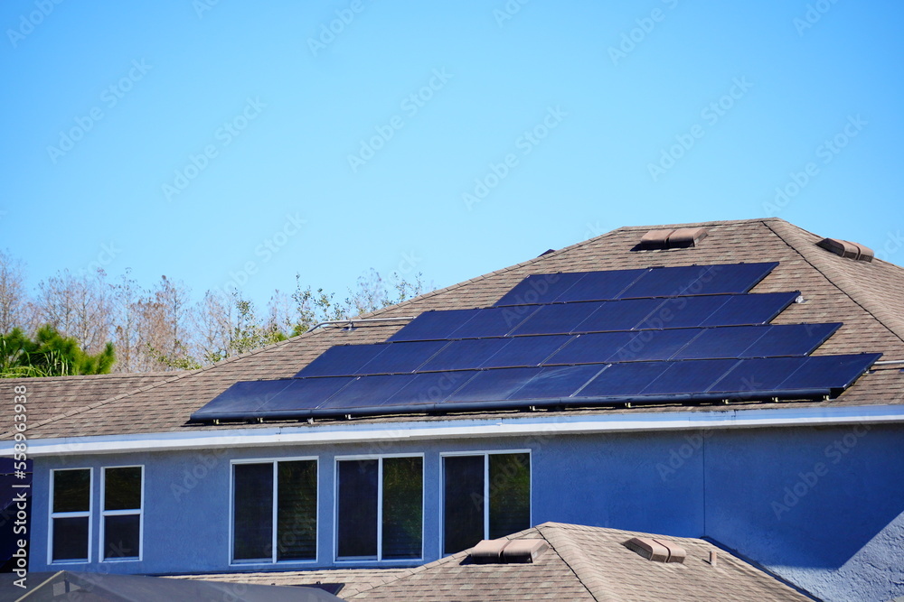 Solar panel on a house roof; Green energy from sun Solar panel on a house roof; Green energy from sun