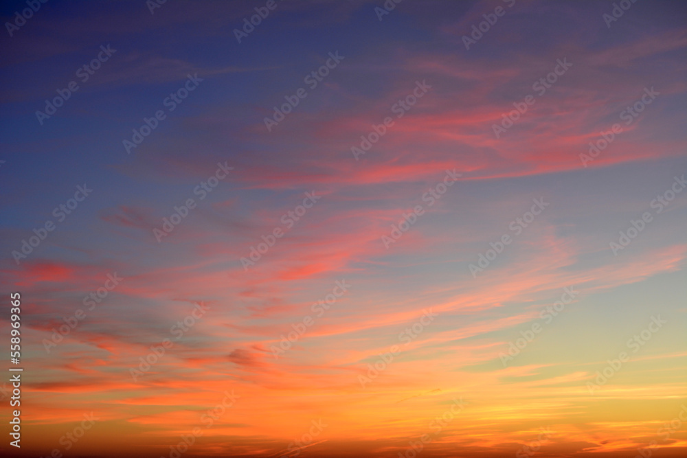 stunning sunset with red, orange and purple clouds on dark sky