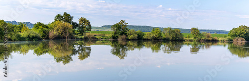 Fototapeta Naklejka Na Ścianę i Meble -  Summer landscape, panorama, with river and trees reflected in river water