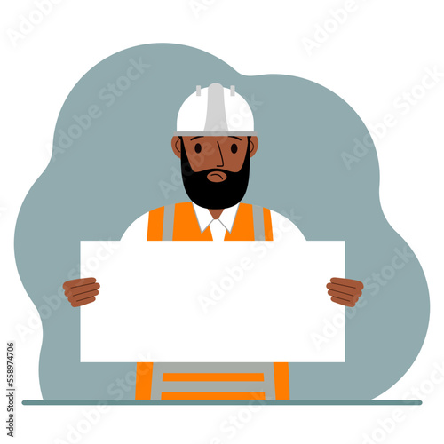 Engineer man holding a blank sheet of paper. The concept of a builder, engineer, planner or designer.