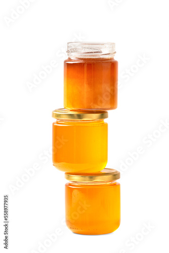 Jars with honey one on top of the other on a white background