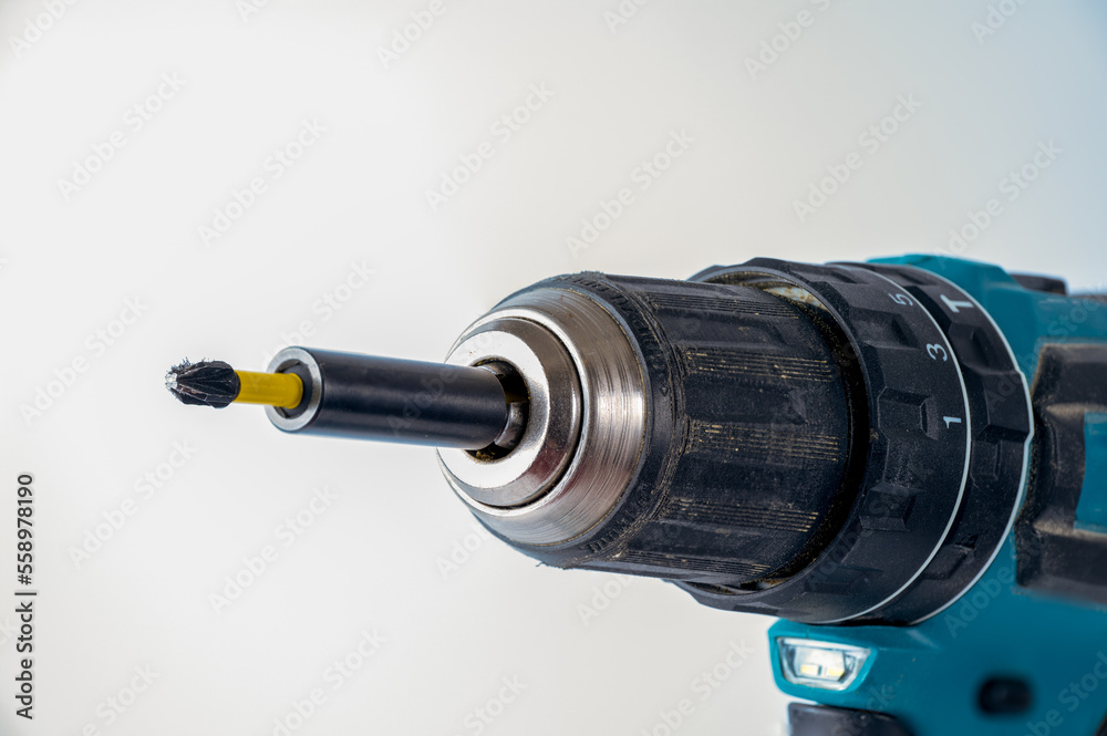 close up of a cross head screw driver bit in a magnetic bit holder of an impact driver battery operated cordless drill close up of a cross head screw driver bit in a magnetic bit holder of an impact driver battery operated cordless drill