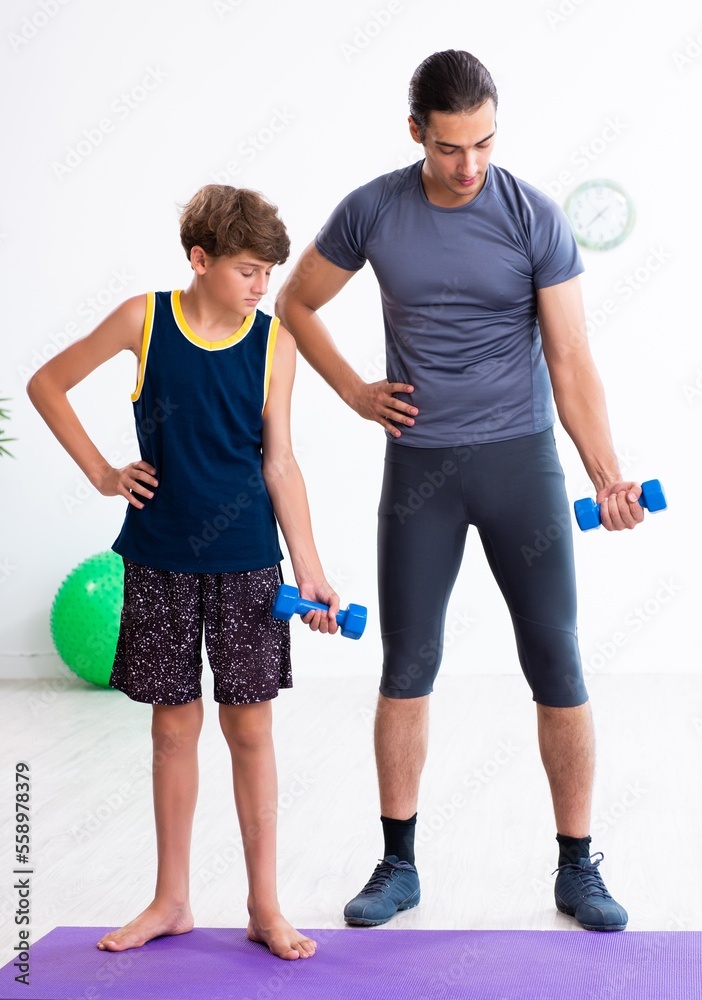 Young father and his son doing exercises Young father and his son doing exercises