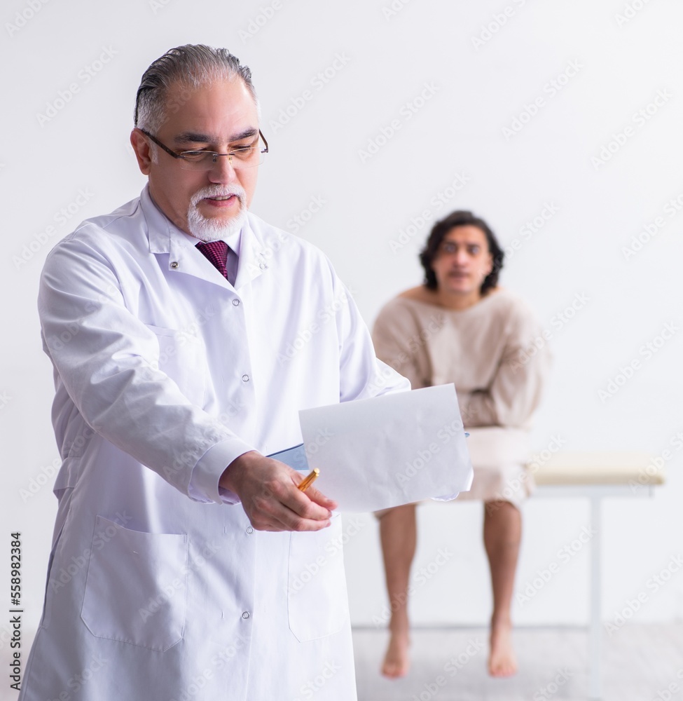 Aged male doctor psychiatrist examining young patient Aged male doctor psychiatrist examining young patient