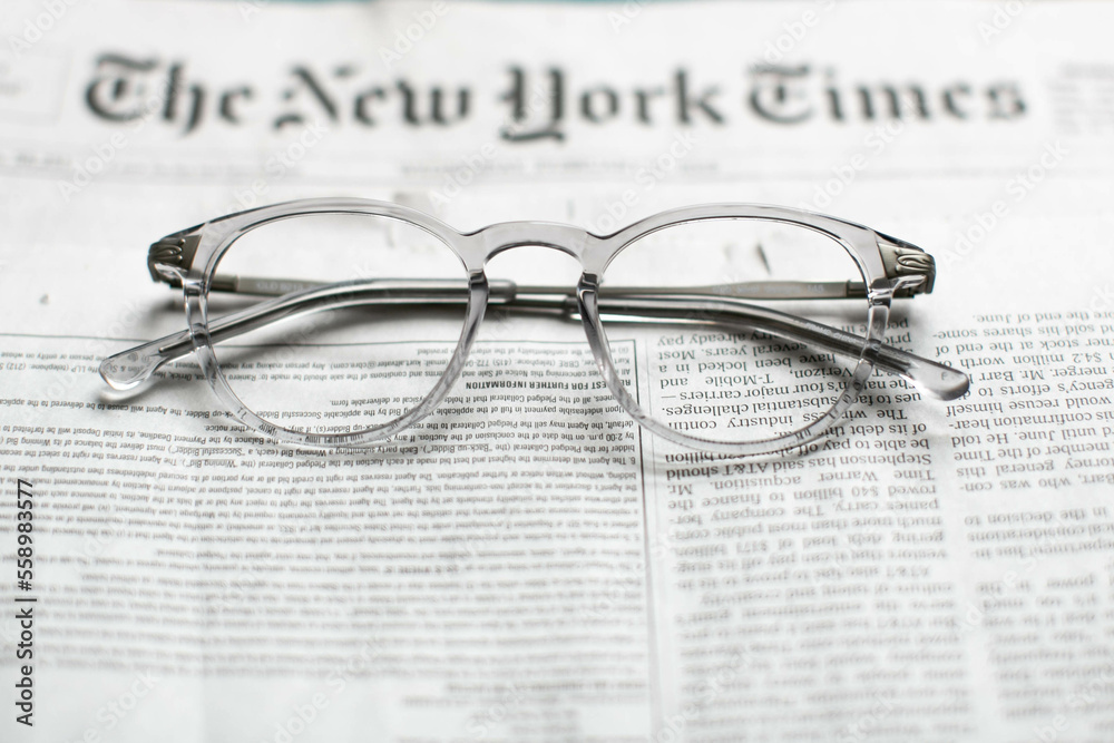 glasses on the newspaper