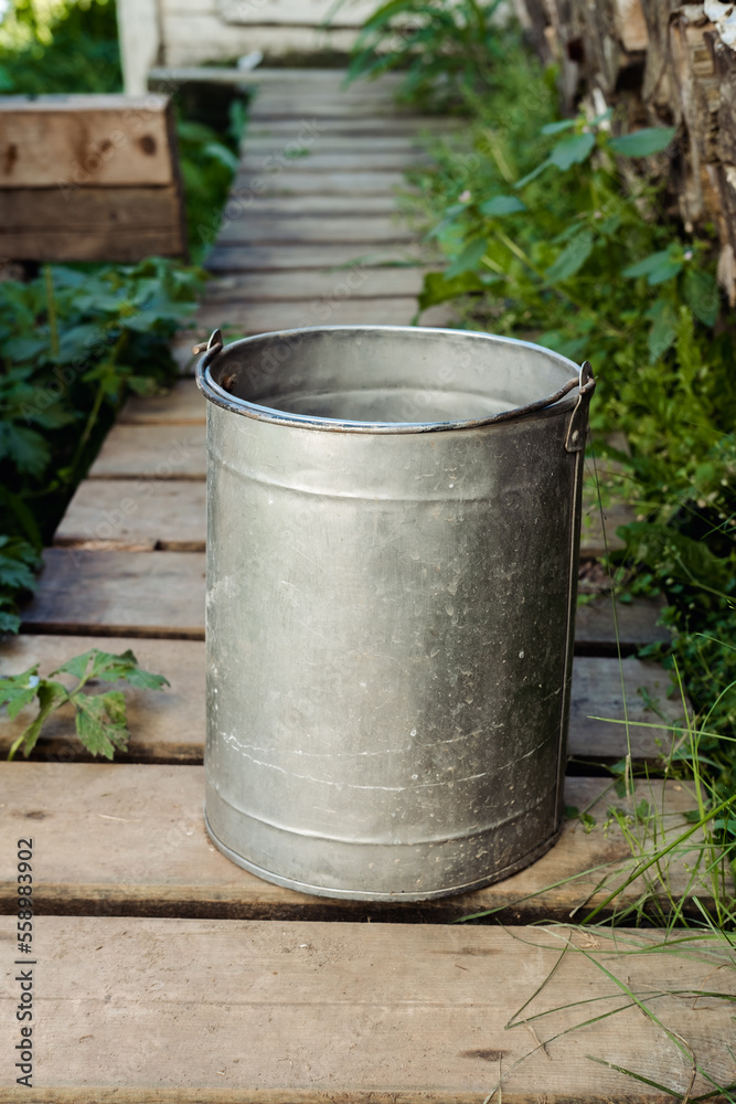 iron bucket with water in the country in the summer iron bucket with water in the country in the summer