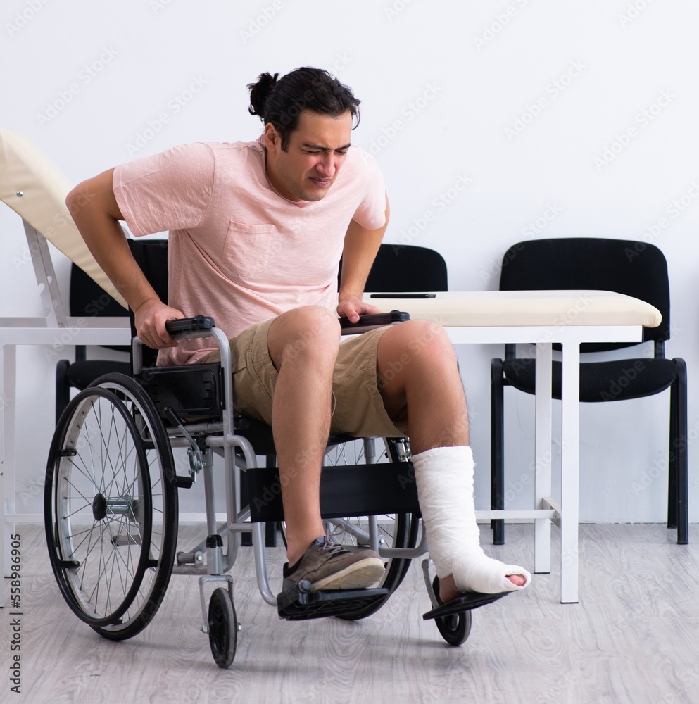 Young injured man waiting for his turn in hospital hall Young injured man waiting for his turn in hospital hall