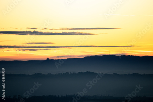 dawn before sunrise in germany swabia with hohenzollern castle at the horizon