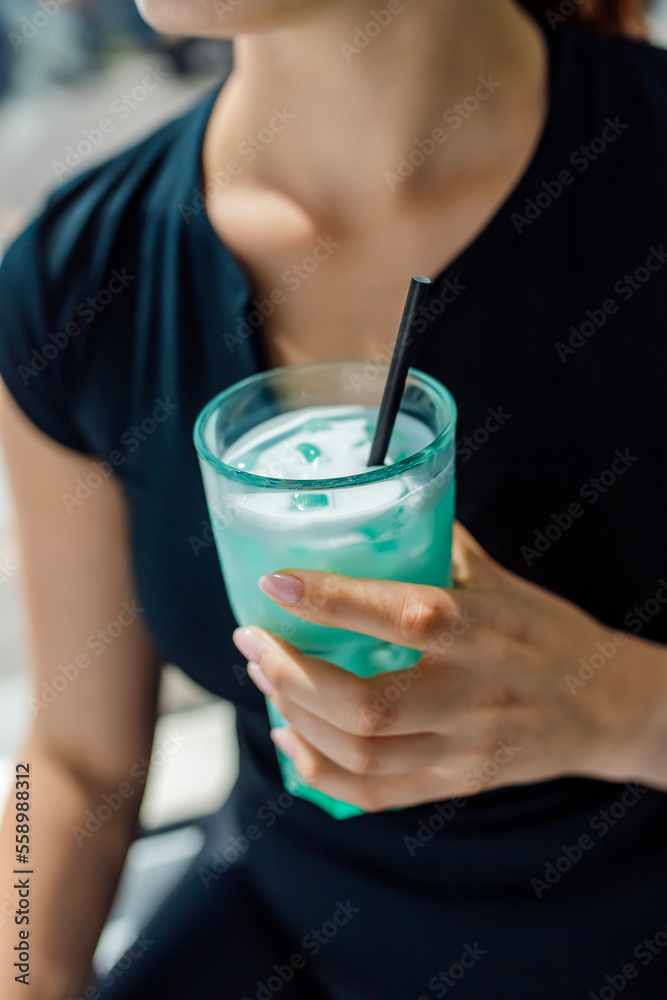 Fitness girl holding a glass with sports nutrition drink