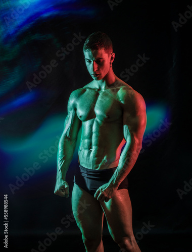 Handsome young male bodybuilder in studio shot