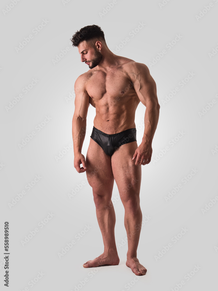 Full figure shot of handsome shirtless athletic young man