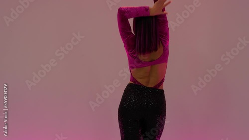 Women performing latin dance on a pink background 