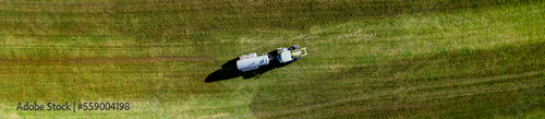 a tractor fertilizes a field from above panorama photo