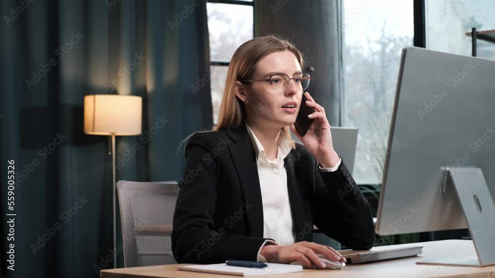 Smiling young business woman professional talking on phone using laptop sit at home office desk, happy female customer make mobile call confirming online website shopping order delivery concept