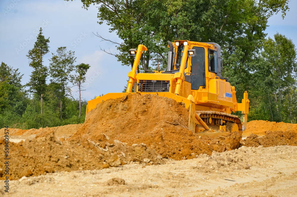 Crawler dozer working on construction site or quarry. Mining machinery moving clay, smoothing gravel surface for new road. Earthmoving, excavations, digging on soils Crawler dozer working on construction site or quarry. Mining machinery moving clay, smoothing gravel surface for new road. Earthmoving, excavations, digging on soils