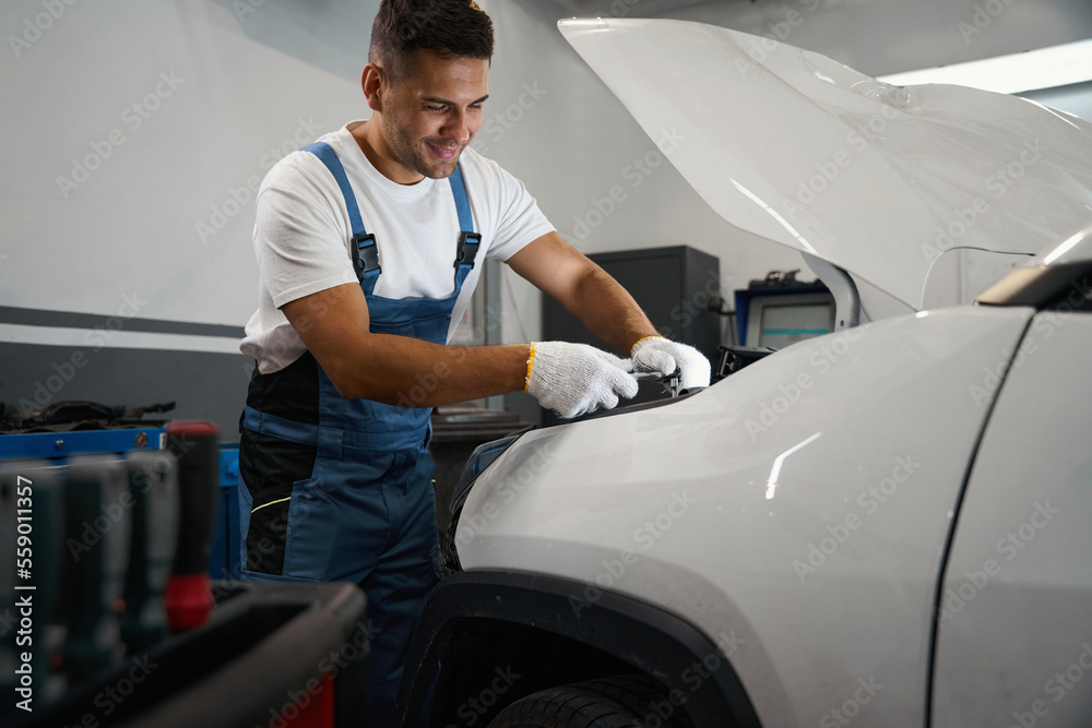 Mechanic inspecting car at a tire shop Mechanic inspecting car at a tire shop