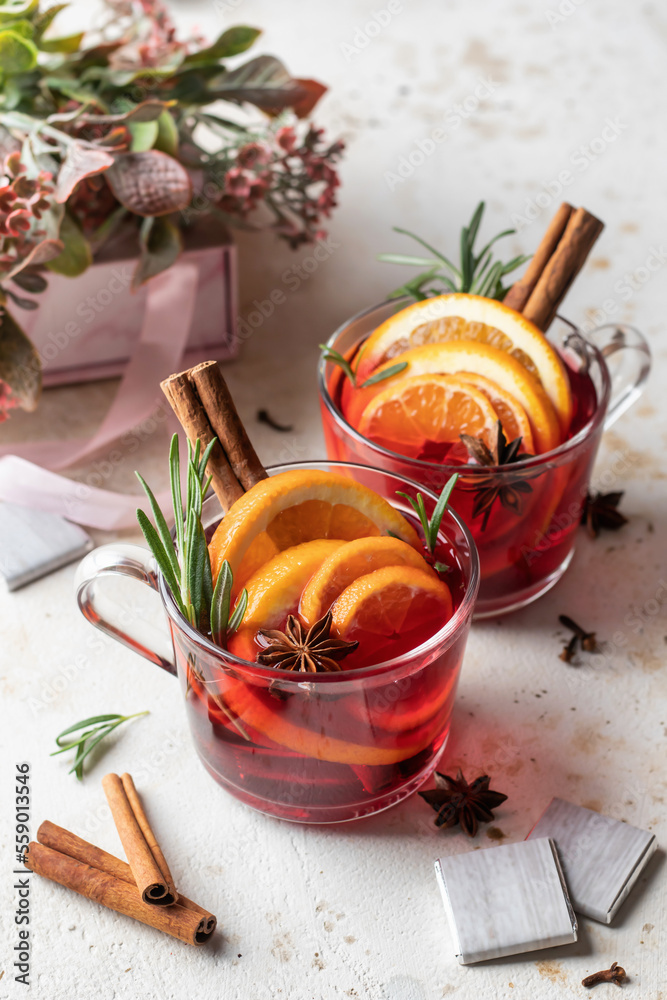 Festive valentines composition with mulled wine, spices, flowers, sweets and gift on white textured background. Valentine' s day surprize for lover or romantic dinner Festive valentines composition with mulled wine, spices, flowers, sweets and gift on white textured background. Valentine' s day surprize for lover or romantic dinner