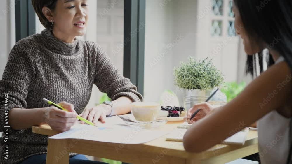Business concept of 4k Resolution. Asian business people having a meeting in a coffee shop. casual business plan. Business concept of 4k Resolution. Asian business people having a meeting in a coffee shop. casual business plan.