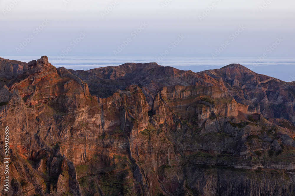 Stunning views after a hard hike to the top of Pico Ruivo in Madeira with a view of Pico do Arieiro during an epic sunset.