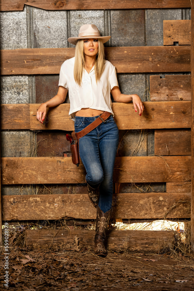 A Lovely Blonde Model In Western Gear Poses Outdoor While Enjoying The Spring Weather