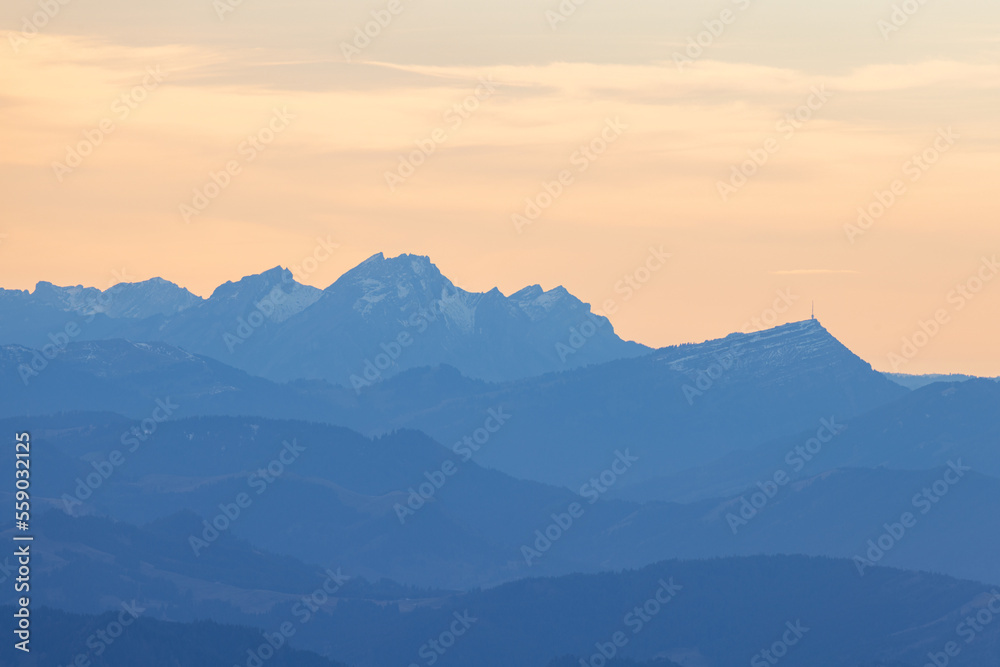 Beautiful colored horizon with red, orange and pink tones behind the mountains of Switzerland.