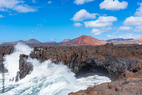 Powerful waves of the Atlantic Ocean crashing on the volcanic cliffs of Los Hervideros in Lanzarote  Canary Islands  Spain