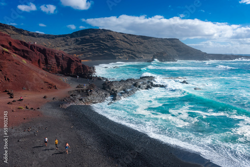 Lanzarote, Spain, 20 March 2022: The Atlantic  Ocean at El Golfo black volcanic beach photo