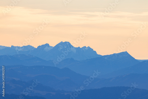Beautiful colored horizon with red, orange and pink tones behind the mountains of Switzerland. © Philip