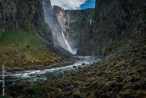 Voringsfossen waterfall with steep mountain cliffs in the valley at Hardangervidda National Park in Norway photo