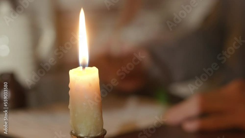 18th century man writing with a quill pen focus on candle photo