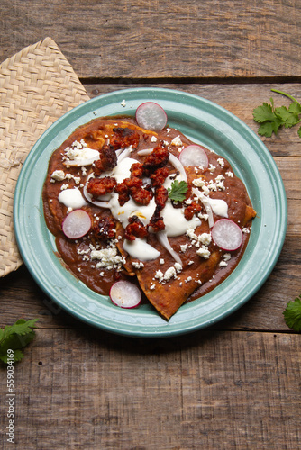 Mexican enfrijoladas with chorizo and fresh cheese