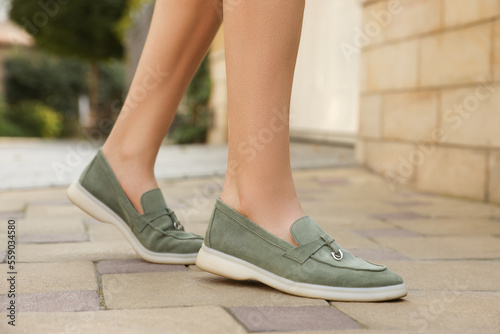 фотографія Woman in stylish loafers walking on city street, closeup