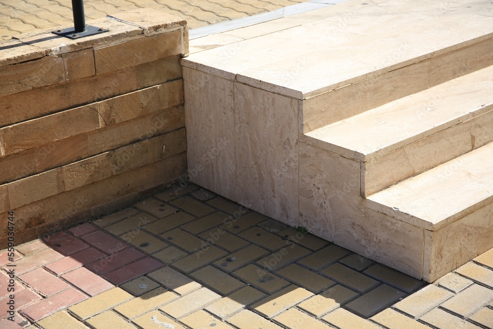 Obraz premium Beautiful concrete stairs near stone pavement outdoors