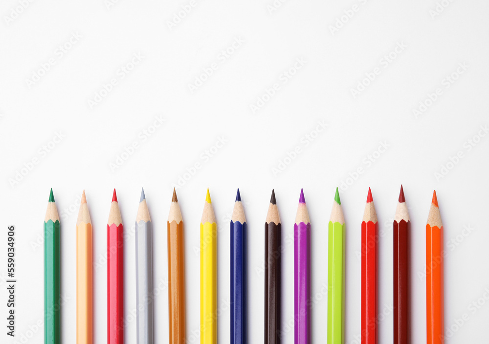 Colorful wooden pencils on white background, flat lay. Space for text Colorful wooden pencils on white background, flat lay. Space for text