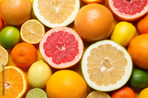Different ripe citrus fruits as background  top view