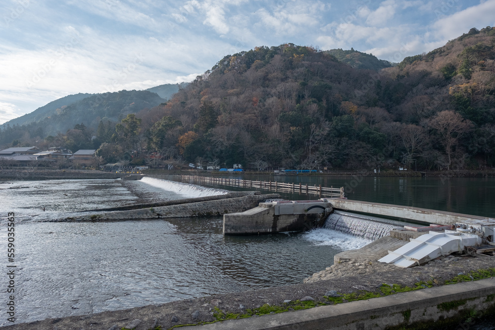 Tourists walking around Togetsu-kyo Bridge wooden river crossing, December 18, 2018, Kyoto, Japan Tourists walking around Togetsu-kyo Bridge wooden river crossing, December 18, 2018, Kyoto, Japan
