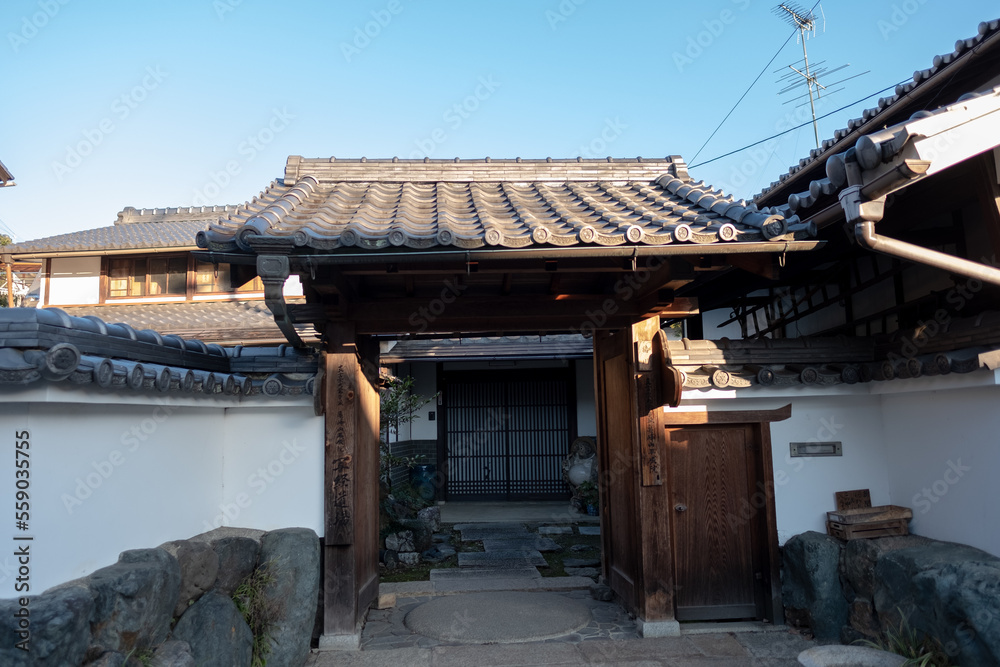 Tori with shrines in front of japanese building, Arashiyama region, Japan, December 18, 2018 Tori with shrines in front of japanese building, Arashiyama region, Japan, December 18, 2018