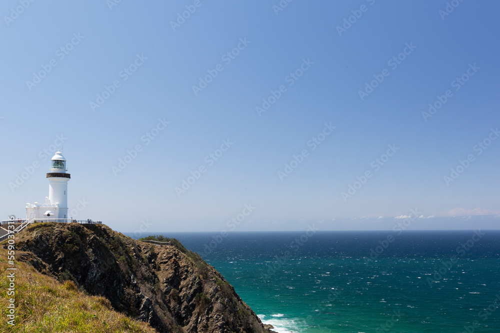 A white lighthouse on a cliff