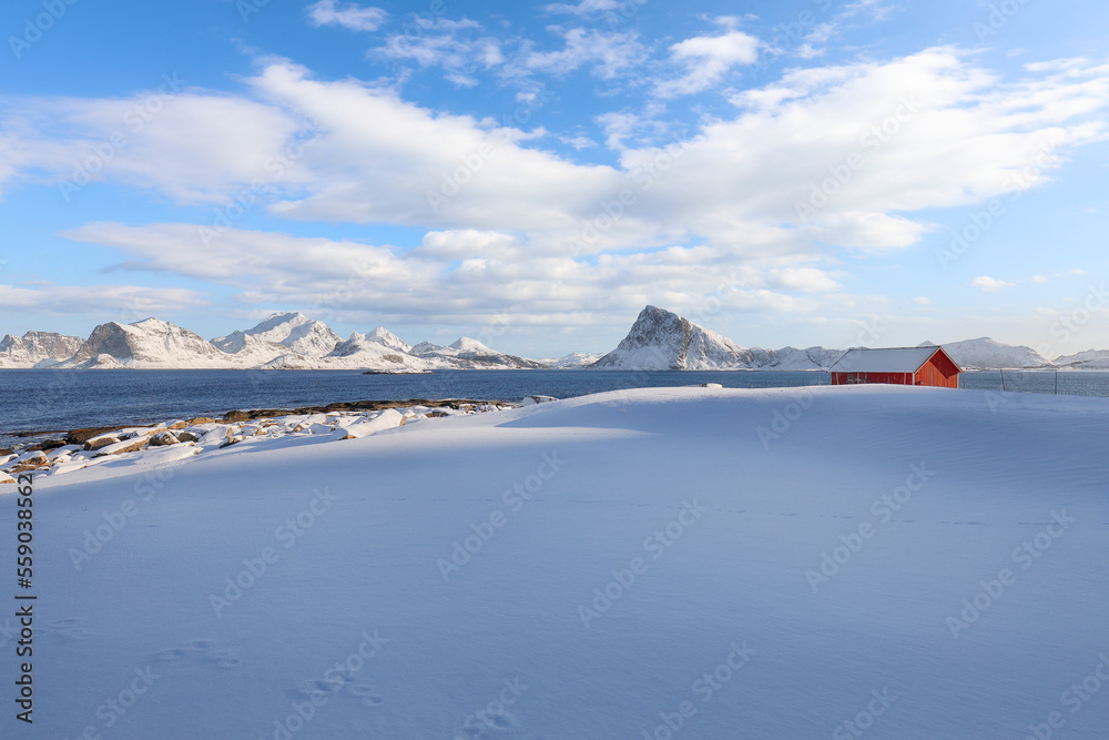 Awesome winter view on Vetvagoy coastline seen from Storsandnes beach in the morning.
