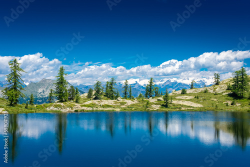 Reflection on the Mount Avic Lake in Aosta Valley,  Italy photo